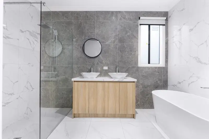 Newly fitted modern bathroom with walk-in shower and twin basins