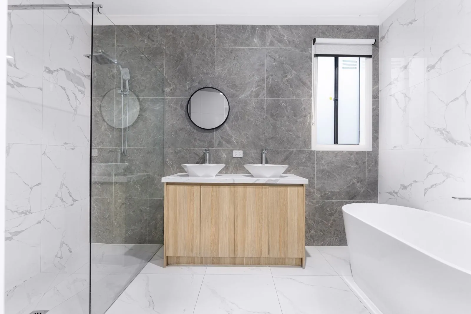 Newly fitted modern bathroom with walk-in shower and twin basins