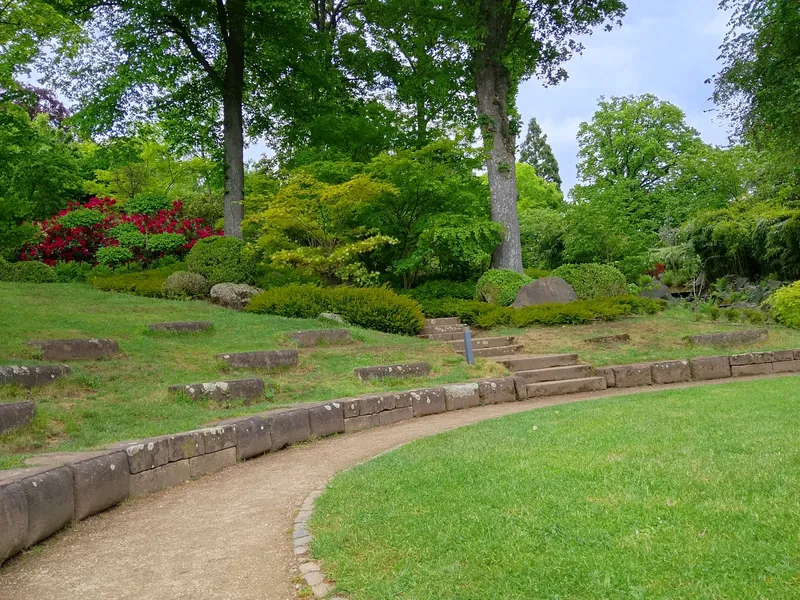Landscaped garden with a stone-edged path, lawn and mature planting