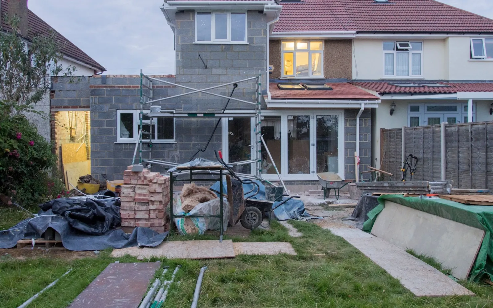 Yellow builders skip sitting on a residential driveway