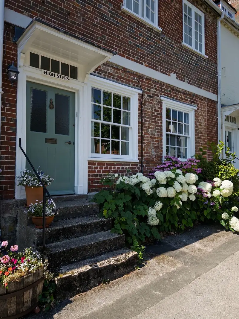 Clean sash windows on a red-brick period house